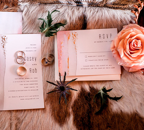 wedding invitations with the rings and a rose 