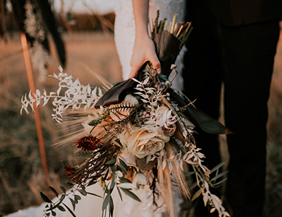 view of a rustic bouquet being held by a bride