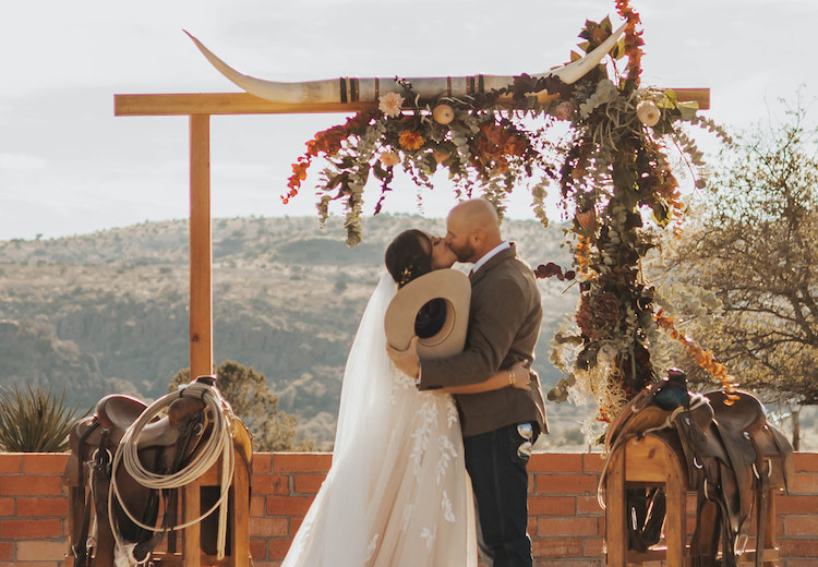 couple kissing at the wedding alter