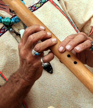 person playing a native flute