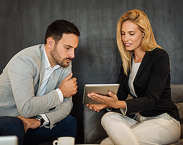 business man and woman looking at an iPad