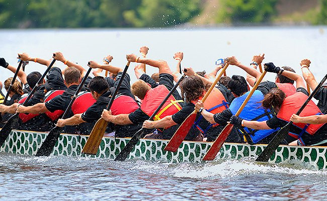 group of people rowing a boat