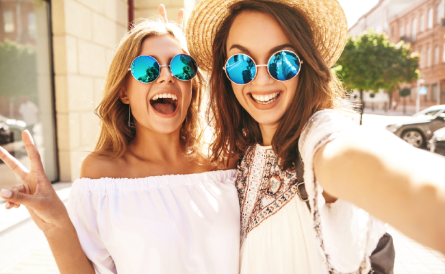 girls taking a selfie with blue sunglasses