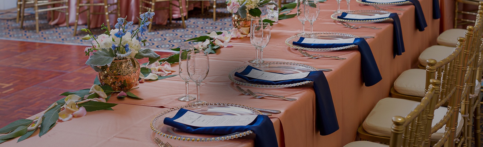 elegant table setup with blue tablecloth and silver napkins