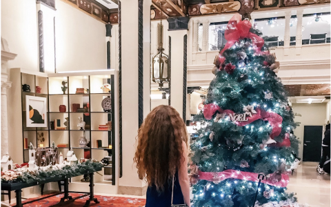 Woman looking at Christmas Tree in hotel lobby