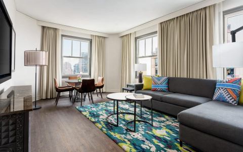 room with blue and green carpet and windows