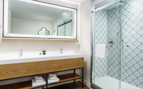 hotel with glass shower doors and white counters