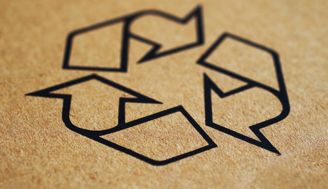 recycle logo printed on a brown background