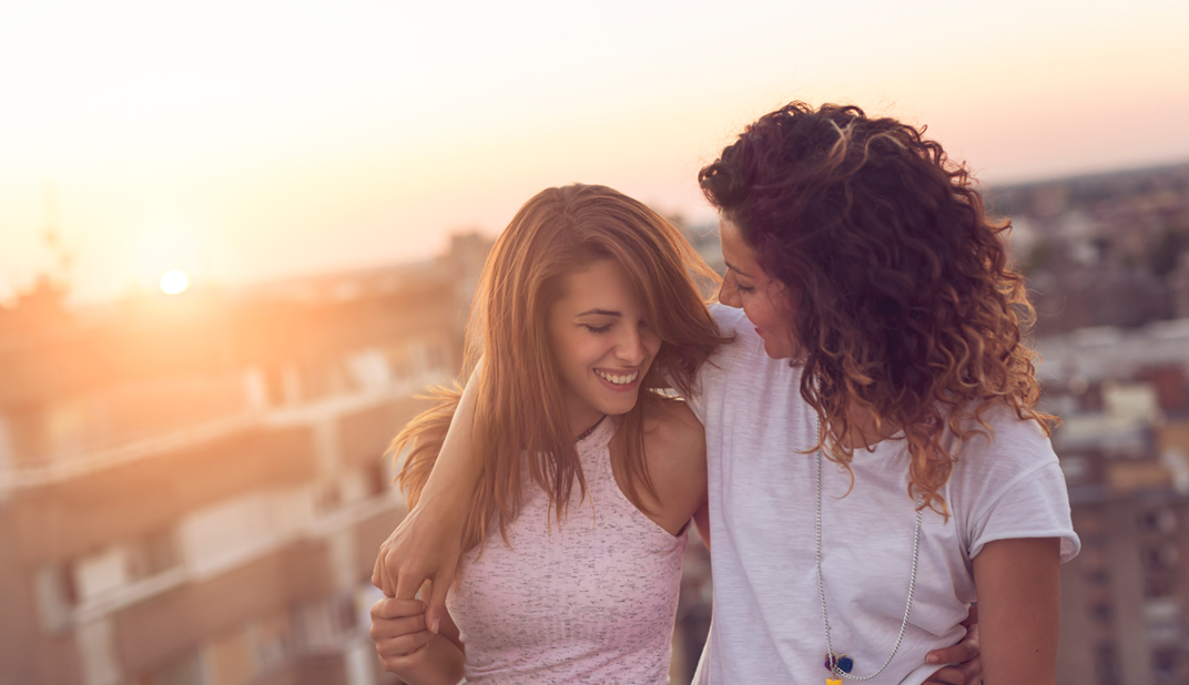 lesbian couple happy in the sunset