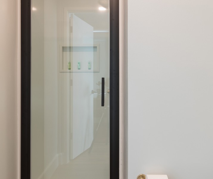 closeup view of a washroom with feature as shower and a toilet paper 