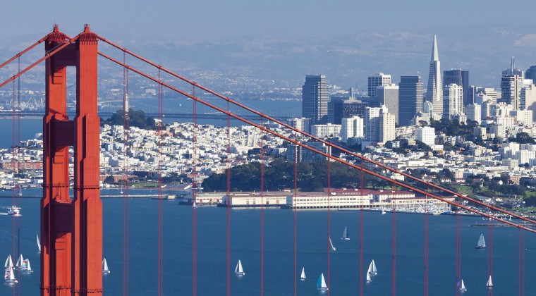 SF view of city in distance behind golden gate bridge