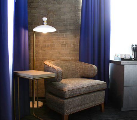 grey chair with purple curtains