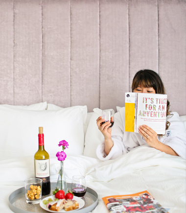 woman reading in bed at hotel trundle