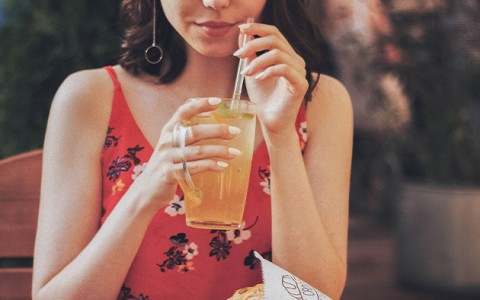 woman holding a drink at a restaurant