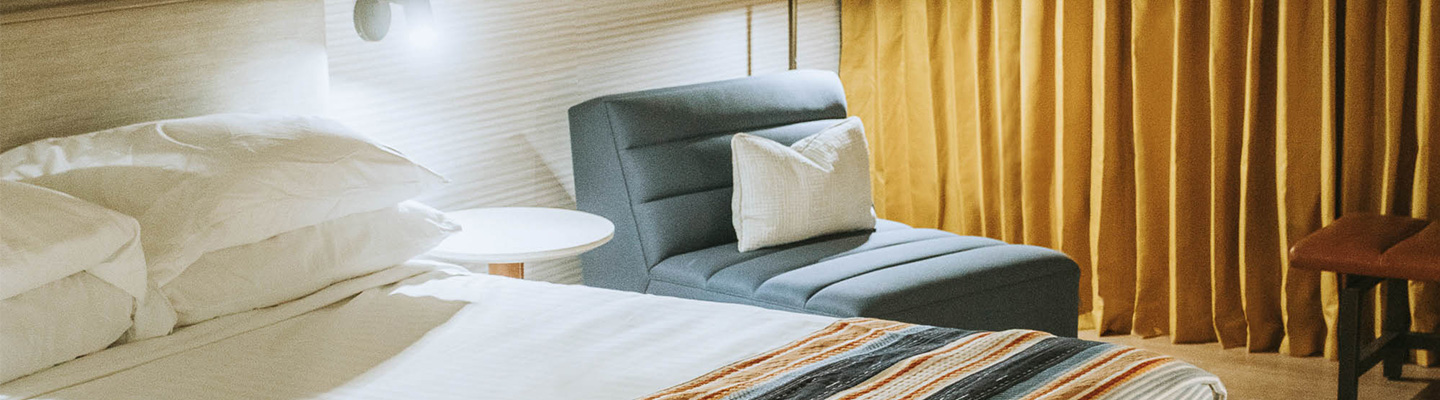 hotel room with bed & chair