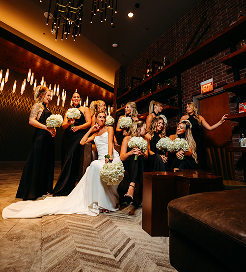 bridesmaids with bouquets and bride posing in the front