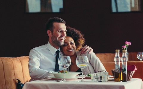 Couple sitting and smiling in a restaurant 