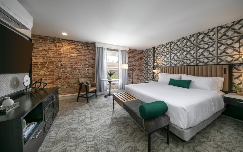 hotel bedroom with brick accent wall