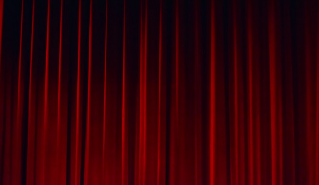 closed red curtain on a theater stage