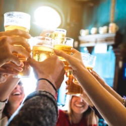 group of friends raising glasses of beer