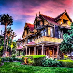 historic mansion exterior with manicured lawn and landscaping