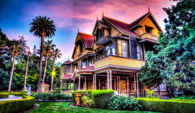 historic mansion exterior with manicured lawn and landscaping