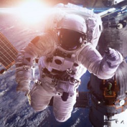 astronaut in floating in space with satellite behind them