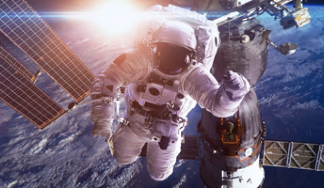 astronaut in floating in space with satellite behind them