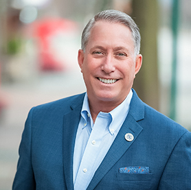 headshot of david martin in a blue suit with blue shirt
