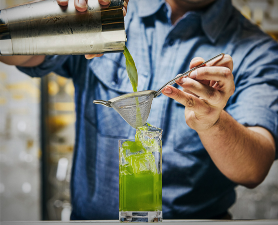 bartender serving an ogre green cocktail