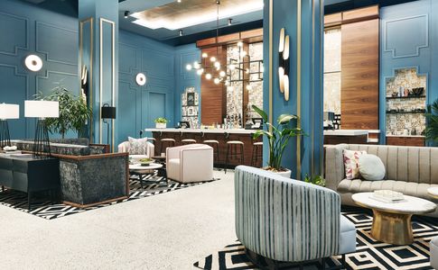 interior lobby of kinley cincinnati with blue painted walls and a striped pattern sofa 