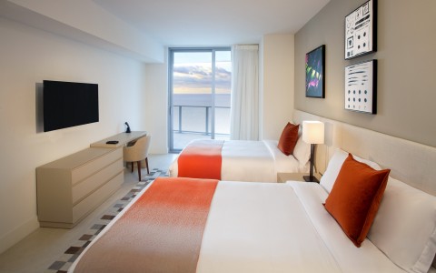 2 bedroom ocean view room, 2 queen beds, desk, dresser, mounted tv, balcony with ocean view