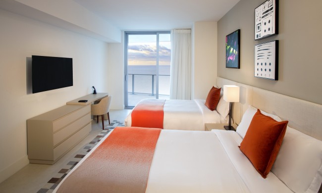 2 bedroom ocean view room, 2 queen beds, desk, dresser, mounted tv, balcony with ocean view