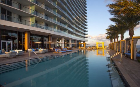 lap pool at Hyde Hollywood Beach surrounded by cabanas, chairs and umbrellas