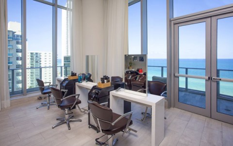 Emena Spa Hair Salon has 3 stations and floor to ceiling windows with doors leading to an ocean view balcony