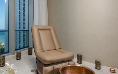 Emena Spa stand alone Pedicure Chair with ocean view behind.