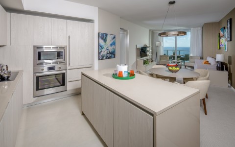 Suite full size kitchen. Full size appliances; sink,over, refridgerator. Large island with 2 stools. Additional table to seat 4. Living room with couch, two chairs and a large balcony over looking the ocean.