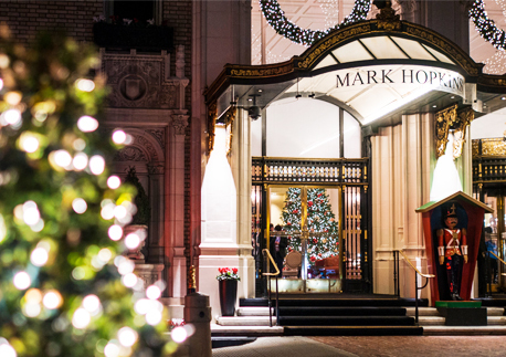 mark hopkins hotel front of the hotel during christmas time eith a life size soldier on the door and christmas trees
