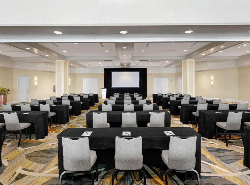 bayfront ballroom with three chairs per table all in line for a meeting or presentation