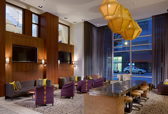 modern lobby area with couch seating, table with stools, and modern design elements