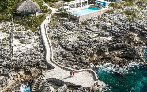 Natural stone staircase from the ocean to the pool and villas.