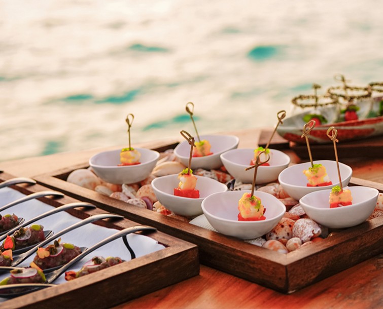 A variety of appetizers on oak table.
