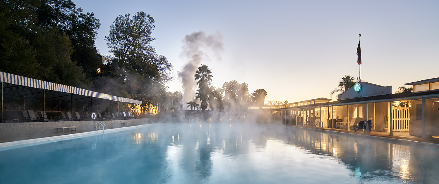 large natural pool with steam rising from water