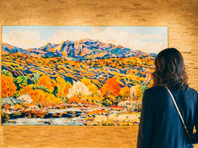 woman looking at painting