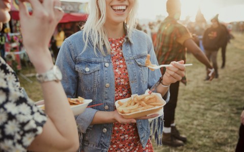 girls eating food at a festival