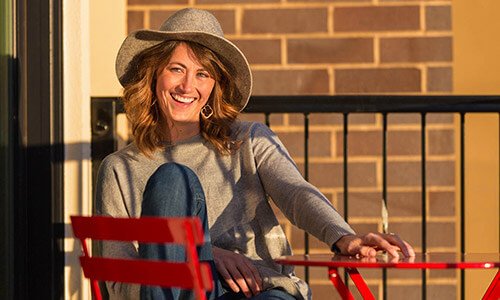 woman sitting outside in red chair