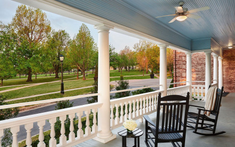 front porch with two rocking chairs looking over the street 1