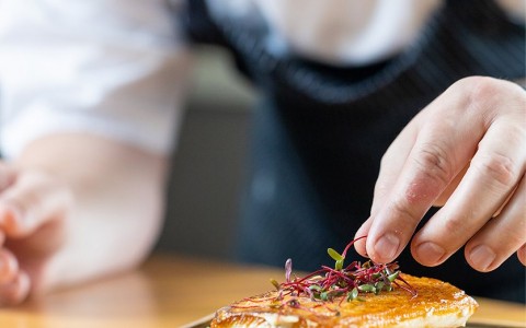 chef plating a fish dish