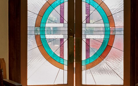 stained glass door with a colorful circular patern