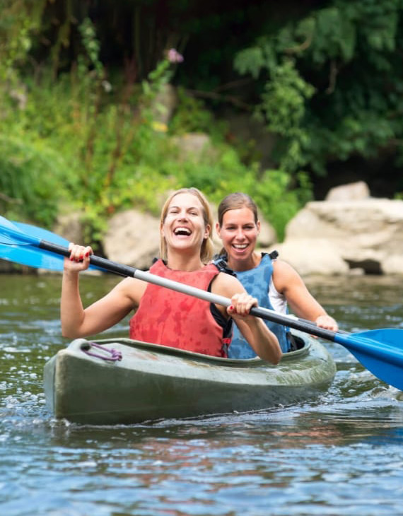2 people paddling in a shared kayak
